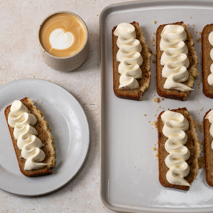 Banana bread with whipped cream cheese ganache by Edd Kimber